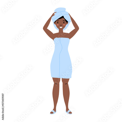 Woman in light blue towel smiling with towel wrapped on her head after shower