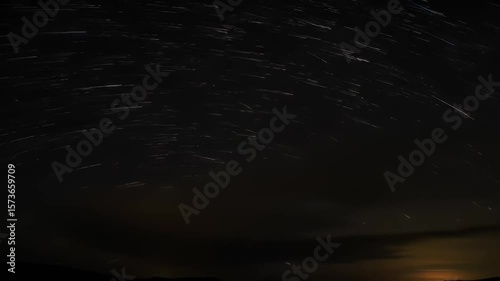 Wallpaper Mural Star trails sweep a dark sky over a hazy landscape Torontodigital.ca
