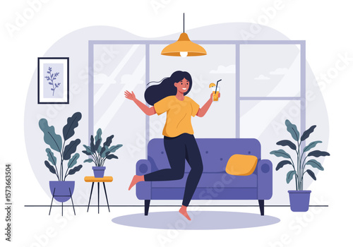 Joyful Woman with Long Dark Hair Leaping on Sofa Holding Orange Drink.