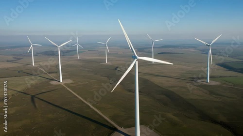 Wind Turbines Stand Tall in a Rural Landscape Under a Clear Sky Powering Green Energy Production