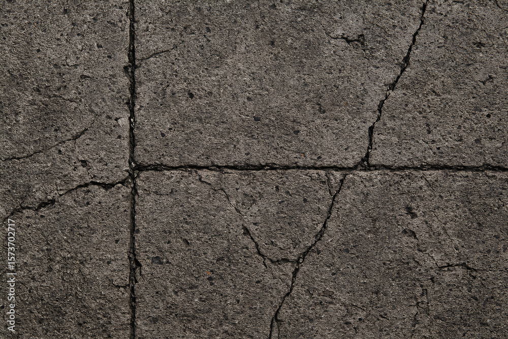 Obraz premium Weathered Concrete Pavement Texture, showcasing a rough, cracked surface with visible signs of aging.