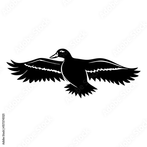 Black silhouette of a duck in flight with wings spread wide