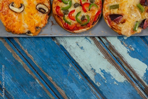 Cropped image of pizzas on weathered table