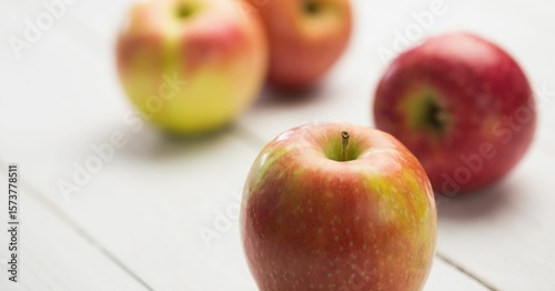 Fresh red apples on wooden table