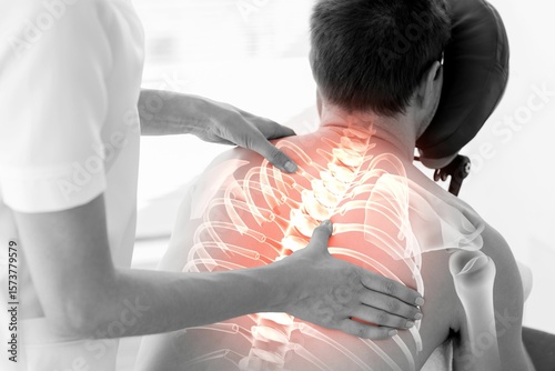 Rear view of injured man having back massage