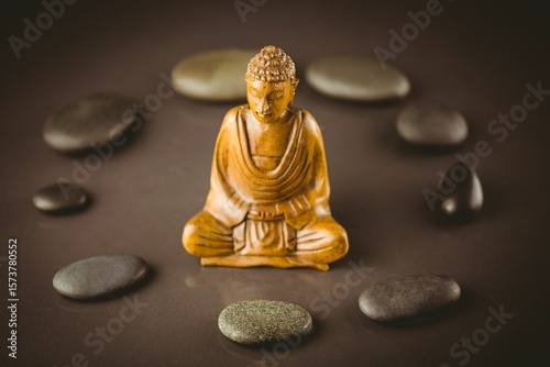 Buddha sculpture surrounded by pebbles