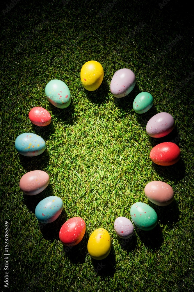 Fototapeta premium Various colorful Easter eggs in circle on grass