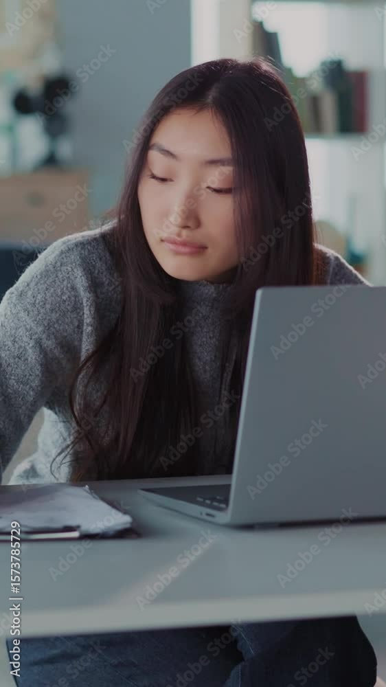 A woman at a desk focused on her laptop, showcasing productivity