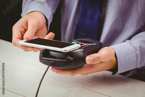 Man using smartphone to express pay
