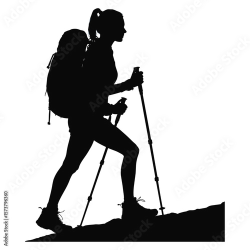 Woman hiker with backpack and poles walking uphill silhouette