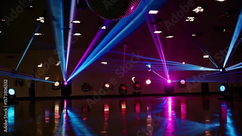 Dynamic nightclub lights illuminate dance floor with vibrant blue and purple laser beams