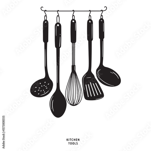 Black and white kitchen tools hanging on a rack perfect for cooking preparation