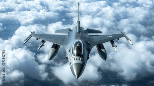 American military fighter aircraft glides high above the clouds, front view