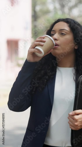Vertical Video of Happy Curly Hair Indian Businesswoman Walking and Drinking Coffee
