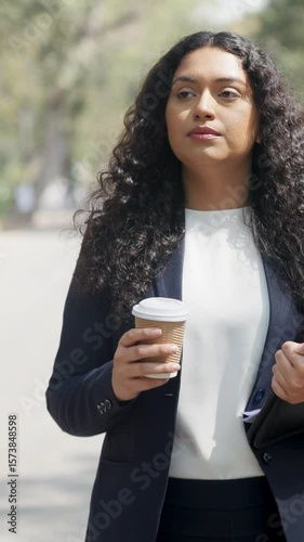 Vertical Video of Serious Curly Hair Indian Businesswoman Walking