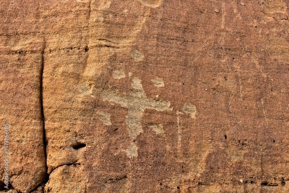 Fototapeta premium Petroglyph of a cross and dots at Aztec Arches area, New Mexico.