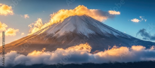 Majestic mountain peak at sunrise, clouds swirling around its base