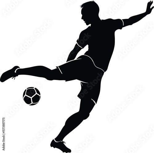 Silhouette of a soccer player kicking a ball in action on the field