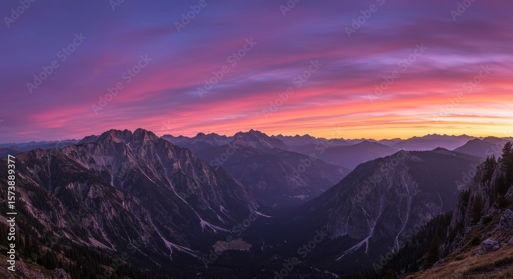 Obraz premium Majestic Mountain Sunset Panorama - Breathtaking panoramic view of mountains at sunset, vibrant pink and purple hues in the sky. Serene landscape