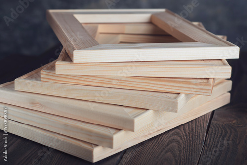 The stretcher bars for stretching the canvas lie on a textured table.