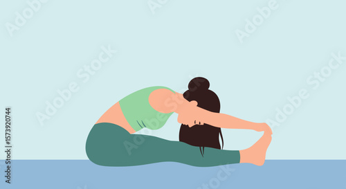 Young woman in forward bend yoga pose on blue background  