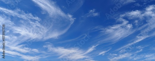 The ethereal beauty of wispy clouds in a bright blue sky.