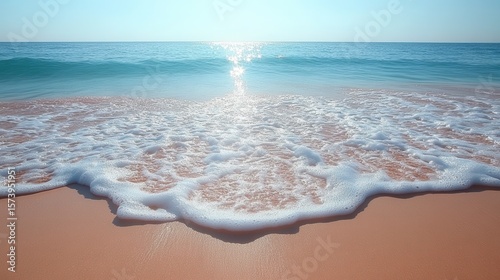 Ocean wave washing ashore, sandy beach, sunny day, calm sea, travel