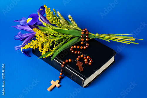 assumption day | Religious book with flowers and rosary beads cross