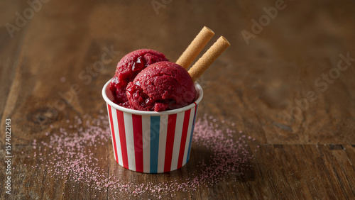 Striped Cup Holding Strawberry Sorbet Captured in Realistic Dessert Scene