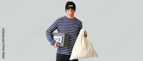 Male thief with bag and saf...