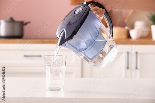 Woman pouring pure water fr...