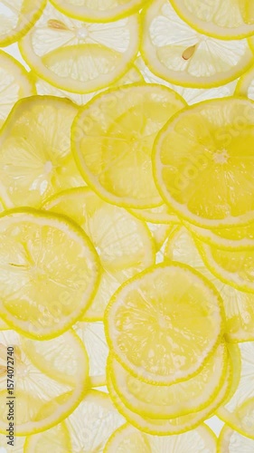 Fresh lemon slices healthy organic food. Sliced lemons falling. Freshness. Vitamin C for skincare, beauty, immunity, healthcare, treatment concept. Ripe juicy lemon slice top view. Diet	
