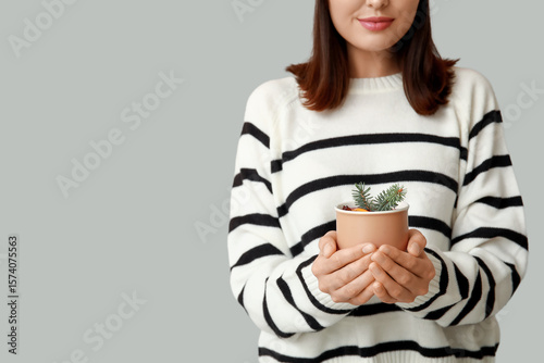 Woman in striped sweater ho...