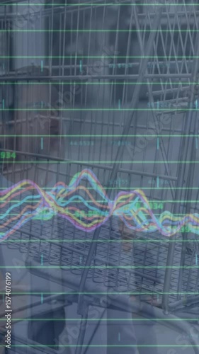 Animation of graphs over supermarket cart and caucasian businessman