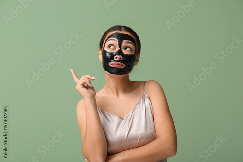 Thoughtful young woman with...