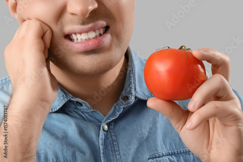 Young man with tomato suffe...