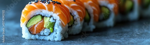 Sushi roll with avocado and salmon on it food background banner copy space