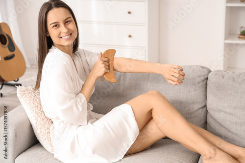 Young woman massaging her a...