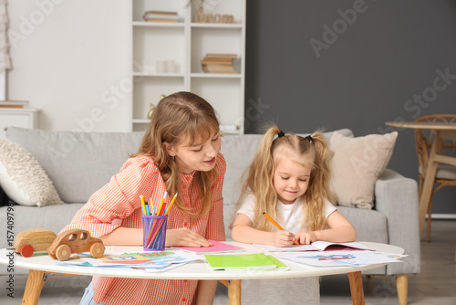 Young girl and teenager dra...