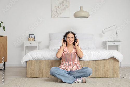 Young woman enjoying music ...
