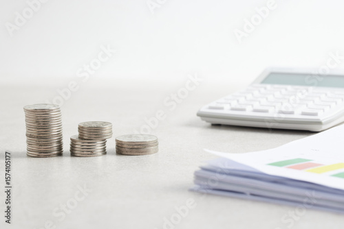 Coins and objects on a table with a financial and economic concept.