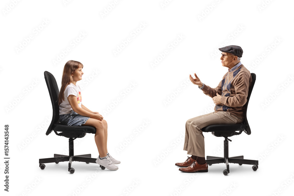 Grandfather sitting and talking to granddaughter Grandfather sitting and talking to granddaughter