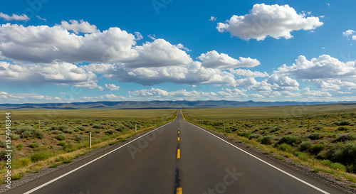Wide Open Rural Road with Blue Sky and Distant Mountains