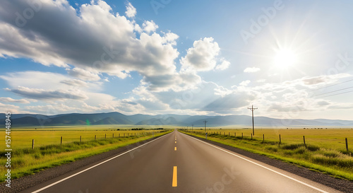 Wide Open Rural Road with Blue Sky and Distant Mountains