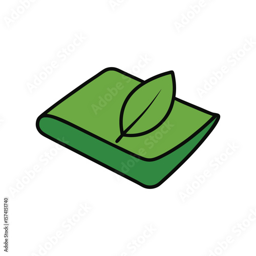 Green leaf resting on a folded green paper