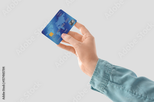 Hand holding a blue credit ...