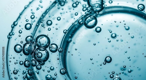 Close-up of clear liquid with bubbles on a glass surface.