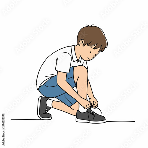 Young boy tying shoelaces on black sneakers in casual outfit  