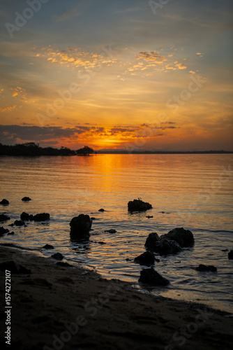 Rocks in the foreground of a sunset view from Morwong Beach, Coochiemudlo Island, Queensland, Australia 