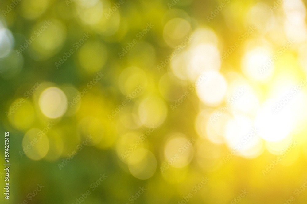Obraz premium Sunlight filtering through green leaves creates a warm, natural bokeh effect. A soft, summery background with gentle light spots and a tranquil atmosphere. 